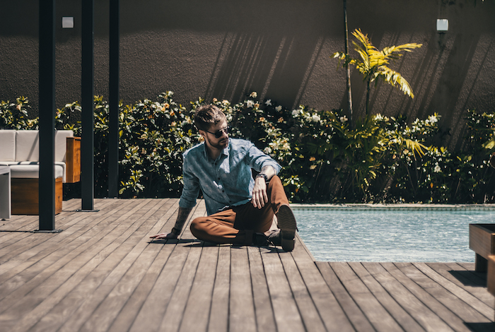 Man sitting by pool